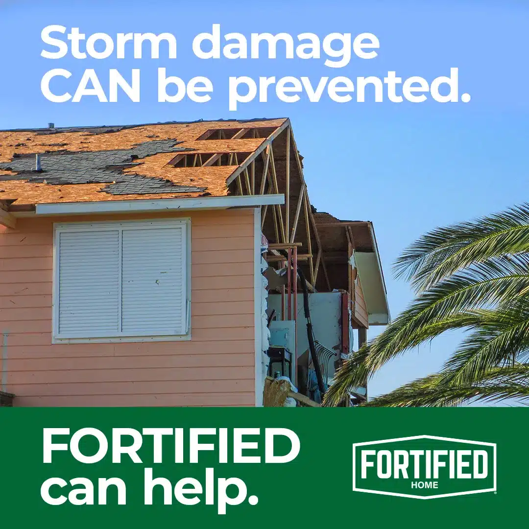 A house with a partially collapsed roof and exposed wooden beams is shown under a clear blue sky. Visible damage suggests a windstorm. Palm trees stand nearby. Text reads: "Storm damage CAN be prevented. FORTIFIED and Halo Roofing can help." FORTIFIED logo is displayed.